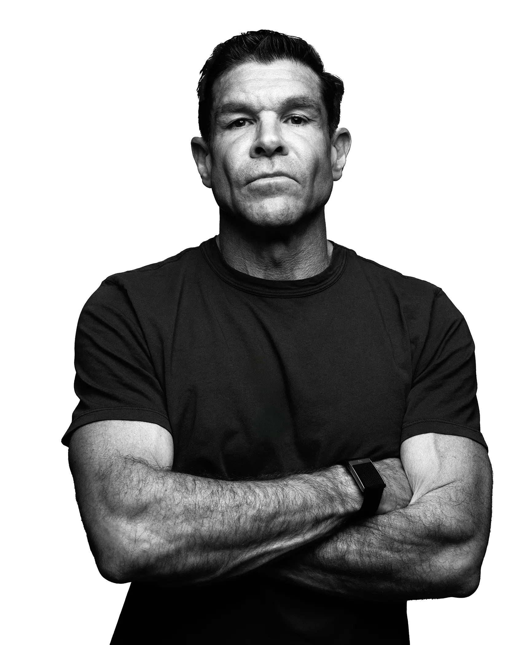 Black-and-white portrait of Ken Rideout, arms crossed, wearing a black t-shirt